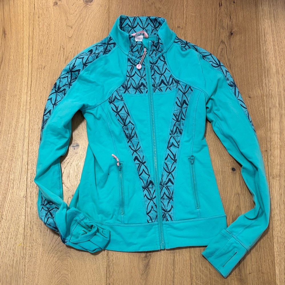 Ivivva Turquoise zip up sweater with black ivivva logo’s design